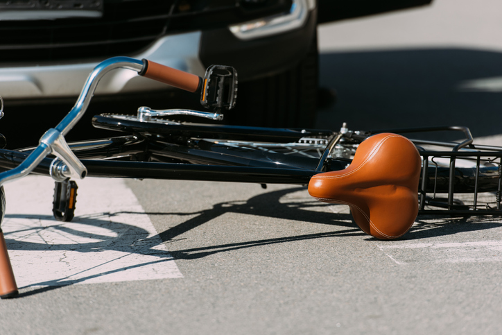 close up view of broken bicycle and car on road, car accident concept